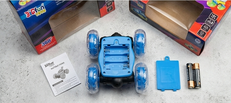 DiCfun 360 stunt car unboxed showing car, battery cover, batteries and instruction manual
